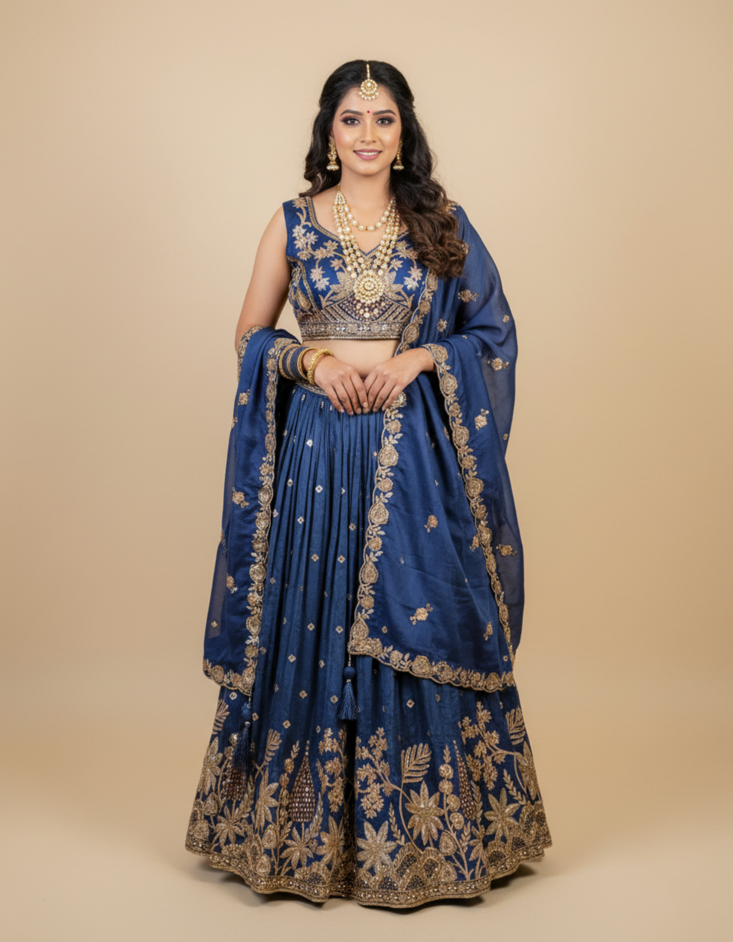 Woman wearing a blue embroidered traditional outfit on a beige background